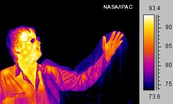 Figure 3: A picture taken in the infrared spectrum is possible because the radiant heat given off by the man is in this spectrum, and can be absorbed by the camera. Notice that some objects are transparent in infrared but opaque in visible spectrums (the bag) and vice versa (his glasses).[6]