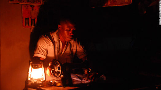 Figure 2. A man working by the light of a kerosene lantern. This type of lighting provides dim light that is not easy to work in. [8]